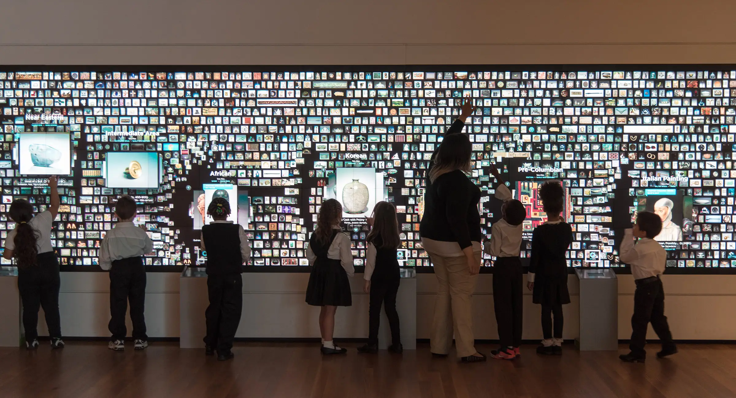 Children interacting with the Collection Wall